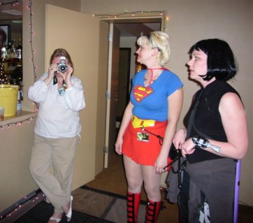 Not Alison taking a picture of a picture being taken, with Supergirl looking on